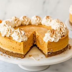 a cheesecake on a plate with one slice cut out