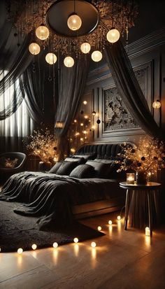 a bedroom decorated in black and white with candles on the floor, chandelier hanging from the ceiling