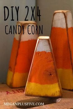 three orange and white candy corn vases sitting on top of a wooden table with text overlay reading diy 2x4 candy corn