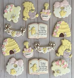 decorated cookies with winnie the pooh sayings and other decorations on a wooden table