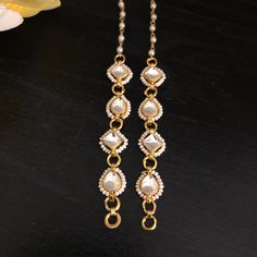 Kundan Earring Support Chain/ Golden Ear Chain/ Kundan Earrings Support Chain/ Kaan Chains/ Earrings Sahara / Jewelry Accessories/ Maatal Features: Made in Brass with 22 Karat Gold plating with Kundan Stones Pair of Two Earrings Support Chains - One for each Ear Used for Earrings Support  Approx. 5 to 5.5 Inches in Length Best support chain for earrings, Studs, Chandbali, and Jhumkas Easy to attach to earrings Metal Pearl Chain Earrings As Gift, Metal Earrings With Pearl Chain As Gift, Metal Earrings With Pearl Chain For Gift, White Pearl Chain Earrings In Metal, White Pearl Chain Earrings For Festivals, White Metal Earrings With Pearl Chain, Gold Pearl Chain Jewelry For Festivals, Silver Pearl Chain Jewelry For Celebration, Silver Jewelry With Pearl Chain For Celebration