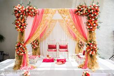 an orange and pink wedding set up