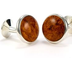 "Imagine yourself in these luxurious Amboyna Burl Wooden Cufflinks and steal the show! Each silver cufflink displays its very own character, color & texture, making them a unique and stylish gift. \"The cufflinks made for your favorite dress shirt\" ► 18 mm (3/4\") diameter fixed-back silver overlay wooden cufflinks ► Add a matching tie bar 6mm x 50mm (1/4\" x 2\") for under $20.00 ► Add 10 mm (3/8\") silver overlay studs (4 or 5 studs), choose from menu ► Natural wood color with a durable g Classic Round Cufflinks For Father's Day, Anniversary Hallmarked Cufflinks, Classic Polished Finish Cufflinks For Father's Day, Oval Cufflinks For Business, Oval Polished Finish Cufflinks For Gift, Oval Polished Cufflinks For Gift, Classic Brown Cuff Jewelry, Classic Round Cufflinks For Gift, Adjustable Polished Finish Cufflinks For Gift