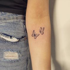 a woman's arm with two butterflies tattoo on the left side of her arm