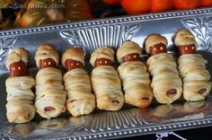 hotdogs wrapped in croissants with mustard and ketchup on them