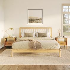 a bedroom with white walls and wooden floors