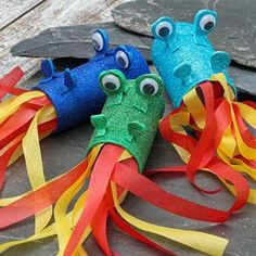 two colorful firecrackers with googly eyes on them sitting next to each other