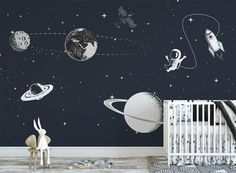 a baby's room with space themed wallpaper