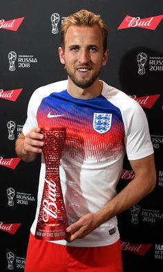 a man in red and blue shorts holding up a tie