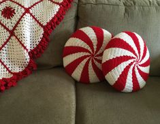 two red and white knitted candy canes on a couch