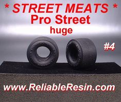 two tires are sitting on top of a black stand with the words, street meats pro street huge