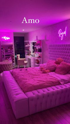 there is a bed with pink lights in the room