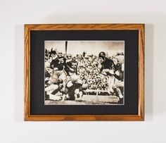 an old black and white photo of a football game