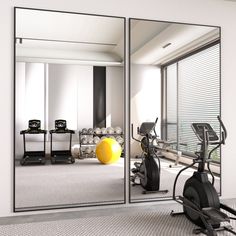 an exercise room with mirrors and treadmills in the foreground as well as a yellow ball on the floor