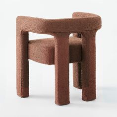 the chair is made out of clay and has a rounded seat that sits on top of it