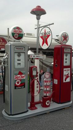 an assortment of gas pumps and signs on display