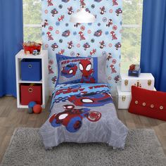 a bed room with a spiderman comforter and curtains