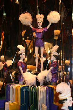 there are many mannequins dressed in different colors and sizes with pom poms