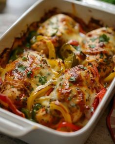 a casserole dish with chicken, peppers and cheese