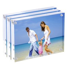 an acrylic photo frame with a family walking on the beach