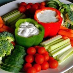 a white plate topped with veggies and dip