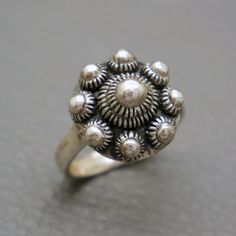 A lovely vintage sterling silver filigree ring, handcrafted in Holland around 1970's. The ring is made of a dome shaped Dutch button, so called Zeeuwse Knoop. Such silver buttons were traditionally hand crafted in traditional Dutch filigree technique. Original piece of collectible Dutch heritage jewelry, suitable for any occasion. The ring will be shipped in a gift box. Ring size: 6 1/4  (US); M 1/2 (UK); diameter: 16.7 mm / European size: 53 1/4 Diameter of the Dutch button is 3/5 inches (1.5 c Dutch Heritage, Heritage Jewellery, Box Ring, Button Ring, Button Jewelry, Sterling Silver Filigree, Filigree Ring, Silver Buttons, Silver Filigree