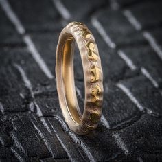 * Price may vary depending on ring size, please inquire with us directly with your needed size for accurate pricing! This Mokume Gane ring is patterned in Arn's signature Guri Bori pattern, which leaves the carved surface as relief showing the layers like topographic lines which match the contours of the carving. Reminiscent of a bird's eye view of a mountain landscape, this ring brings the timeless beauty of nature to a beautiful ring you can treasure. This Guri Bori Mokume Gane ring is shown i Formal Handmade Brass Ring, Modern Handmade Yellow Gold Rings, Brass Rings With Polished Finish For Wedding, Yellow Gold Brass Promise Ring, Luxury Brass Rings For Anniversary, Luxury Adjustable Engraved Round Ring, Luxury Adjustable Engraved Ring, Unique Rings With Polished Round Band, Unique Rings With Polished Finish And Round Band