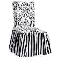 a black and white striped chair with a skirt on it's seat cover that has an ornate design