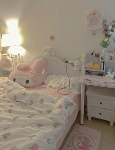 a bedroom with hello kitty bedding and pink flowers on the bedspread, two nightstands are next to each other