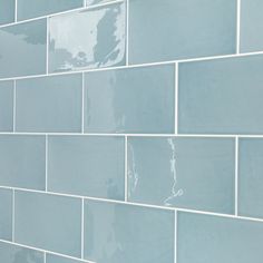 a blue tiled wall with white grouting