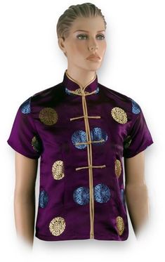 - This Gold and Blue Shou Purple Chinese Shirt exudes a super luxe look with its deep shade of purple, gold and royal blue accents of the Chinese symbol for Shou, and matte gold Chinese button knots! - Processing Time: 1 to 2 Business Days (Excludes Shipping Time) - Made of 55% Rayon, 45% Polyester - Dry-clean recommended - Mandarin collar - Short sleeves - Button-down style - Chinese button knot closure - Hemline hits at the hips - Available in women's sizes. - Imported from China. Ships from P Festive Long Sleeve Purple Top, Fitted Blue Top With Stand Collar, Gold Short Sleeve Tops For Formal Occasions, Festive Fitted Purple Top, Fitted Purple Top For Festive Season, Fitted Purple Top For Festive Occasions, Traditional Fitted Purple Top, Fitted Traditional Purple Top, Elegant Purple Short Sleeve Tops