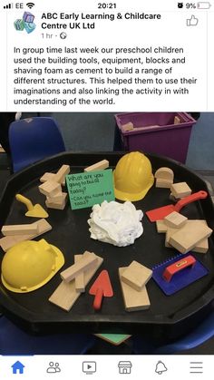 a black tray filled with wooden blocks and construction hats