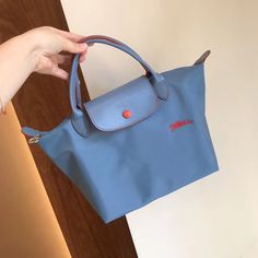 Longchamp Le Pliage Club 70th S Haze Blue Women's Handbag Canvas Tote Small Foldable Dimensions : 9.1 In (L - Measured At The Base Of The Bag) X 8.7 In (H) X 5.5 In (W) Material : Polyamide Fabric With A Minimum Of 70% Recycled Fibre, With Inner Coating Trimming : Leather (Cowhide) Closing : Zipped And Snap Closure Handle Height : 9 Cm / 3.5 In Classic Light Blue Travel Bag, Classic Light Blue Shoulder Bag For Everyday Use, Light Blue Travel Bag With Detachable Strap, Classic Light Blue Shoulder Bag For Travel, Blue Everyday Bags With Snap Closure, Light Blue Travel Bags With Leather Handles, Classic Blue Shoulder Bag With Leather Handles, Blue Bag With Snap Closure For On-the-go, Classic Blue Bag With Snap Closure