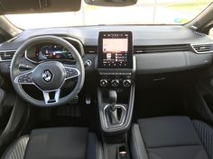 the interior of a car with dashboard, steering wheel and info display on the screen