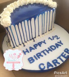 a blue and white birthday cake in a box