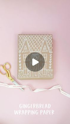 a pink background with scissors, tape and a gingerbread wrapping paper on it that says gingerbread wrapping paper