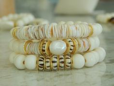 This listing is for a bone bead and shell bracelet set. There are 3 bracelets in this set that can be worn together, as a set of 2, or just one bracelet. The neutral colors easily go with anything and can be dressed up or down for a casual boho luxe vibe. Listing is for the set or just buy one bracelet. Beads are between 8 and 10mm. Bracelets measure 7 inches each. More from my spring summer collection: www.etsy.com/shop/SoCalLux?ref=seller-platform-mcnav&section_id=37561207 To view my shop clic White Heishi Beads Bohemian Stretch Bracelet, Bohemian White Heishi Beads Stretch Bracelet, Bohemian White Pearl Bracelet For Beach, White Bohemian Shell Bracelet, White Bohemian Beaded Shell Bracelets, Bohemian Beaded Shell Bracelets, Cream Bracelets With Round Beads For Beach, Cream Round Beads Bracelets For Beach, Bohemian Pearl Bracelet For Beach