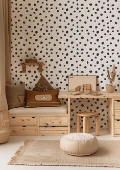 the room is decorated with black and white polka dot wallpaper, including a desk