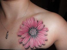 a woman with a pink flower tattoo on her chest