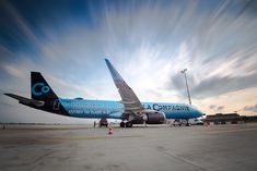 an airplane sitting on the tarmac at an airport