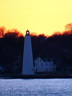 a light house sitting on top of a body of water