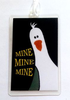 a white bird with an orange beak is on a black and white square ornament