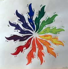 an artistically designed piece of paper with different colored leaves in the shape of a flower