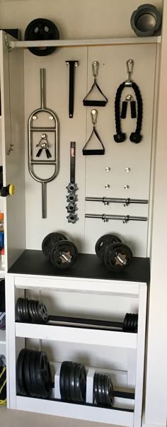 there are many different types of gym equipment in this room, including dumbbells and barbell bells