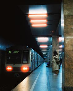 a subway train pulling into the station at night