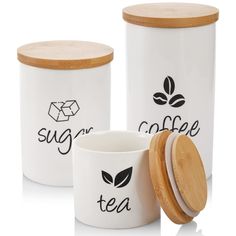 two white coffee mugs with wooden lids are next to each other and the words sugar tea on them