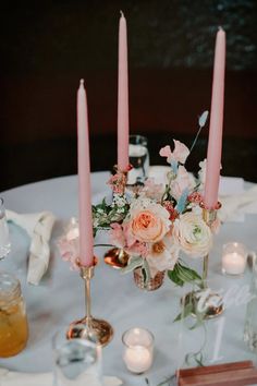 a table with candles and flowers on it