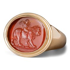 Experience the power of love with the Cupid riding a lion ring. Set in 18K gold on carnelian, it embodies 'Love Conquers All.' A perfect fusion of mythology and sentiment. Custom stones available. The Minotaur, Lion Ring, Ancient Mythology, Gold Signet Ring, A Symbol, 18k Gold Ring, Wide Band Rings, Signet Ring, Handcrafted Jewelry