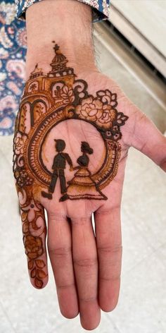 a person's hand with a henna on it and a clock in the middle