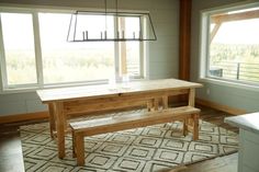 a wooden table and bench in a room